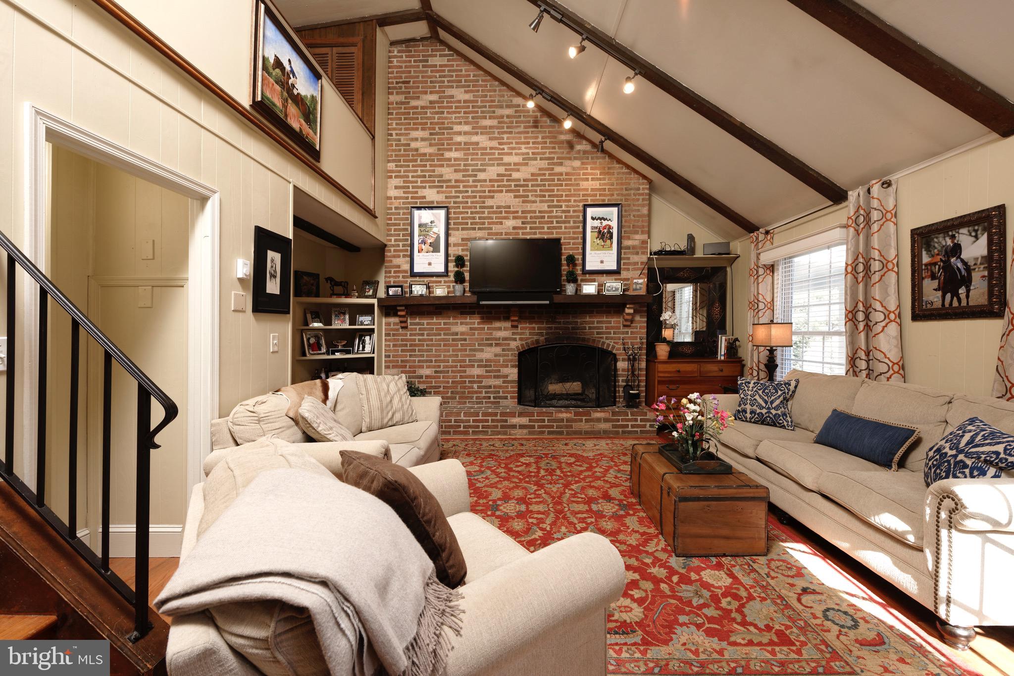 1608 Zulla Road Middleburg, VA 20117 - Photo 7 of 52 a living room with furniture a fireplace and a flat screen tv