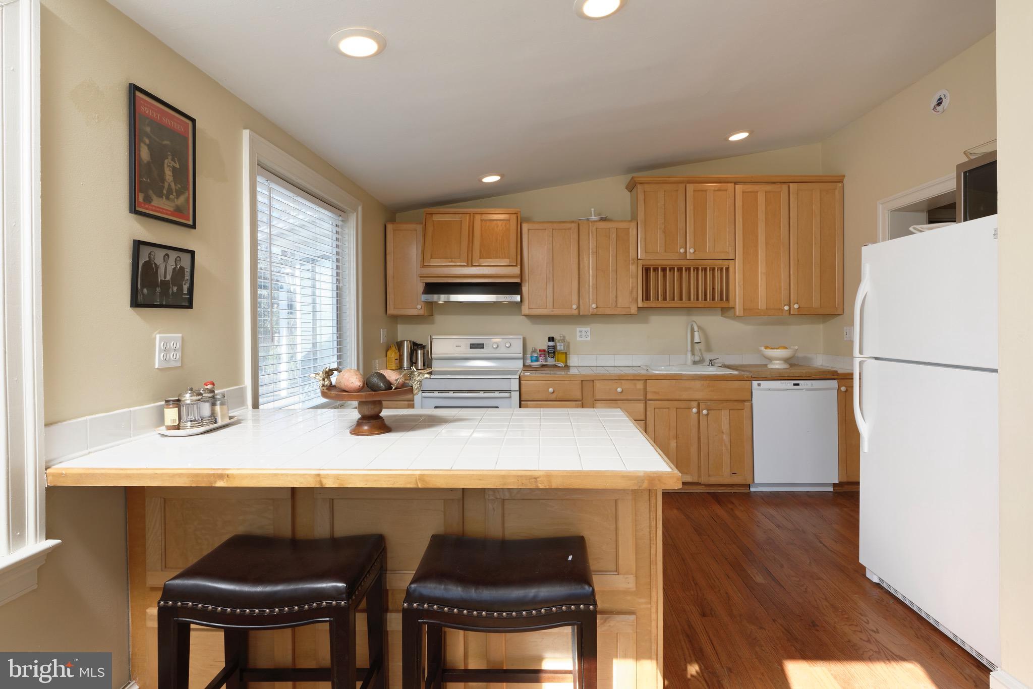 1608 Zulla Road Middleburg, VA 20117 - Photo 9 of 52 a kitchen with a sink a stove a refrigerator and white cabinets