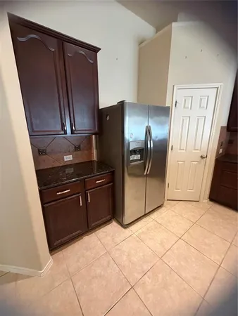 a view of a hallway with wooden floor and a chandelier
