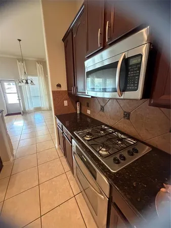 a view of a kitchen with a sink and a fireplace
