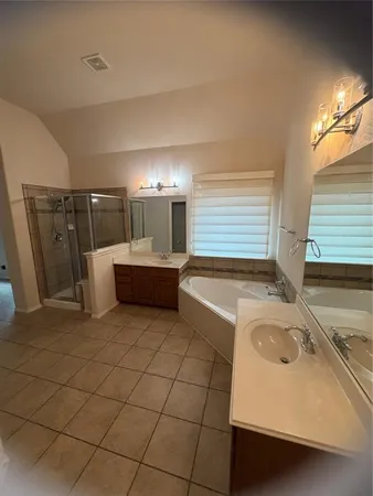 an empty room with ceiling fan and window