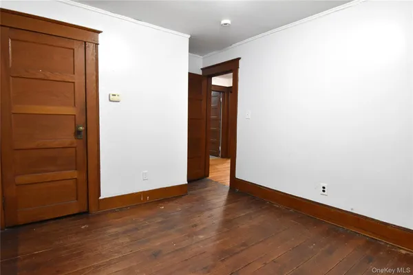 an empty room with wooden floor and closet