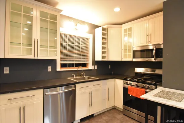 a kitchen with stainless steel appliances granite countertop a sink and a stove