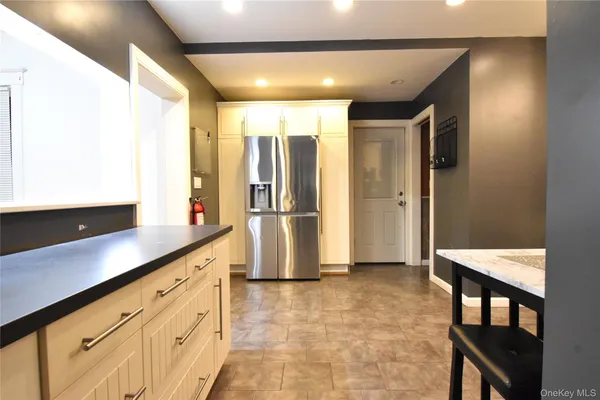 a kitchen with refrigerator and cabinets