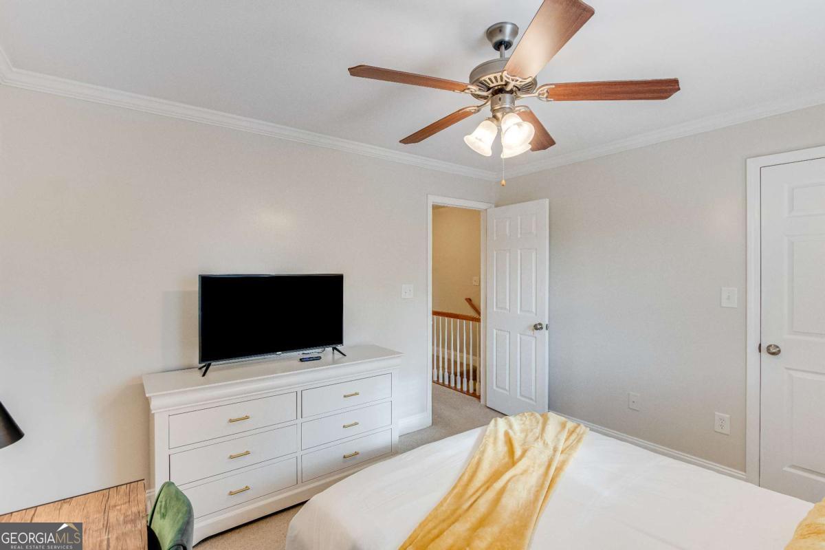 105 Whitehead Road, Unit 25 Athens, GA 30606 - Photo 8 of 12 a bedroom with a bed and flat screen tv