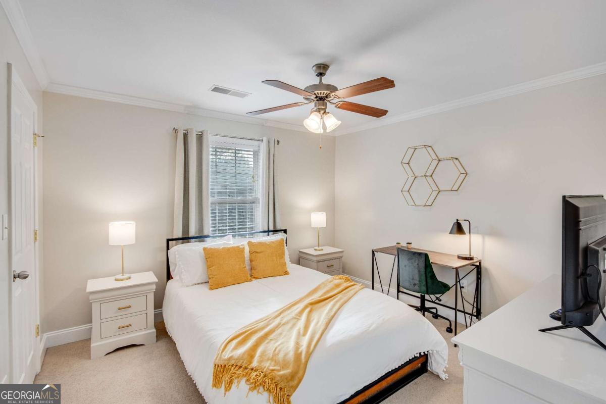 105 Whitehead Road, Unit 25 Athens, GA 30606 - Photo 9 of 12 a bedroom with a bed and a chandelier