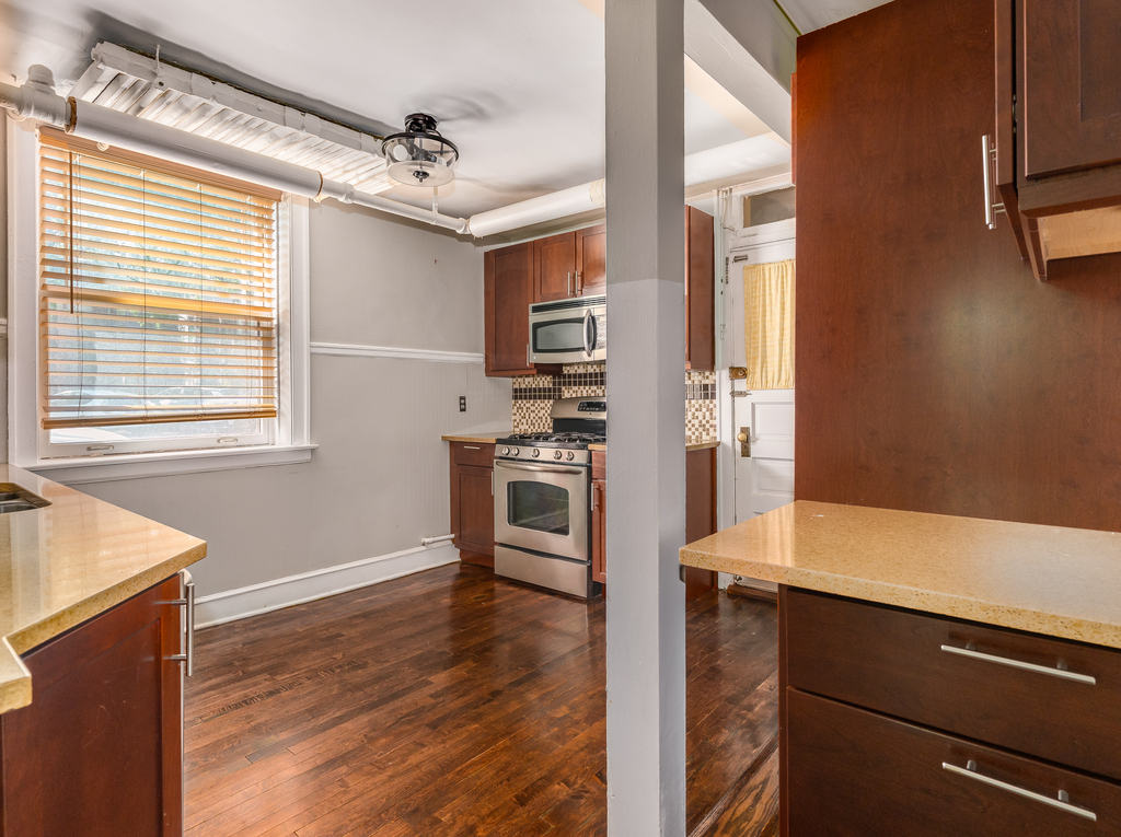 520 Sheridan Road, Unit G Evanston, IL 60202 - Photo 11 of 16 a kitchen with stainless steel appliances granite countertop a refrigerator and a stove
