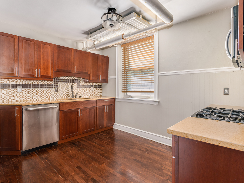 520 Sheridan Road, Unit G Evanston, IL 60202 - Photo 12 of 16 a kitchen with a stove a sink and wooden floor