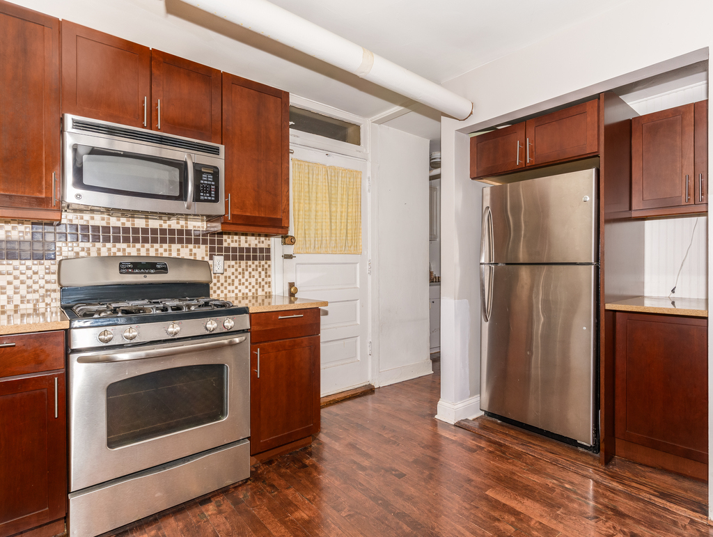 520 Sheridan Road, Unit G Evanston, IL 60202 - Photo 13 of 16 a kitchen with stainless steel appliances granite countertop a refrigerator stove and microwave