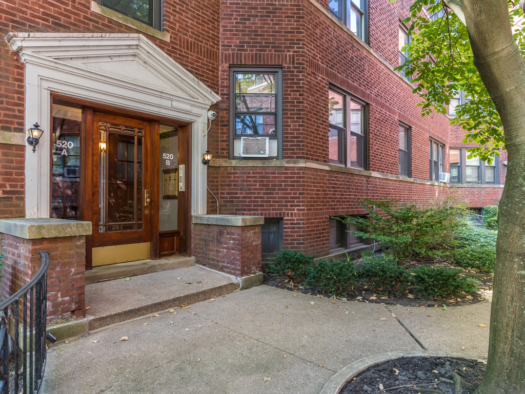 520 Sheridan Road, Unit G Evanston, IL 60202 - Photo 2 of 16 a view of a brick building with potted plants in front of door