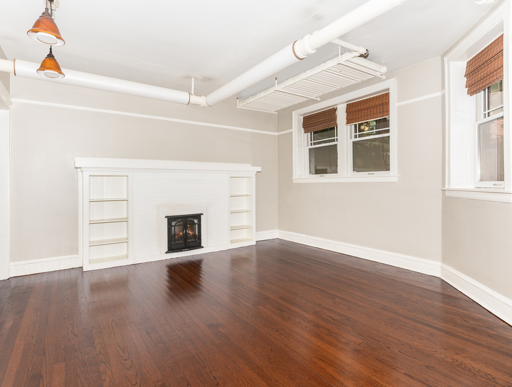 520 Sheridan Road, Unit G Evanston, IL 60202 - Photo 3 of 16 a view of empty room with wooden floor and fireplace