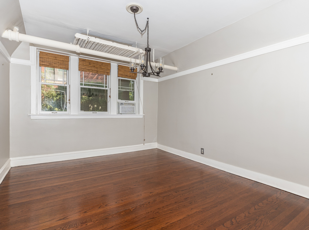 520 Sheridan Road, Unit G Evanston, IL 60202 - Photo 6 of 16 an empty room with wooden floor a ceiling fan and windows