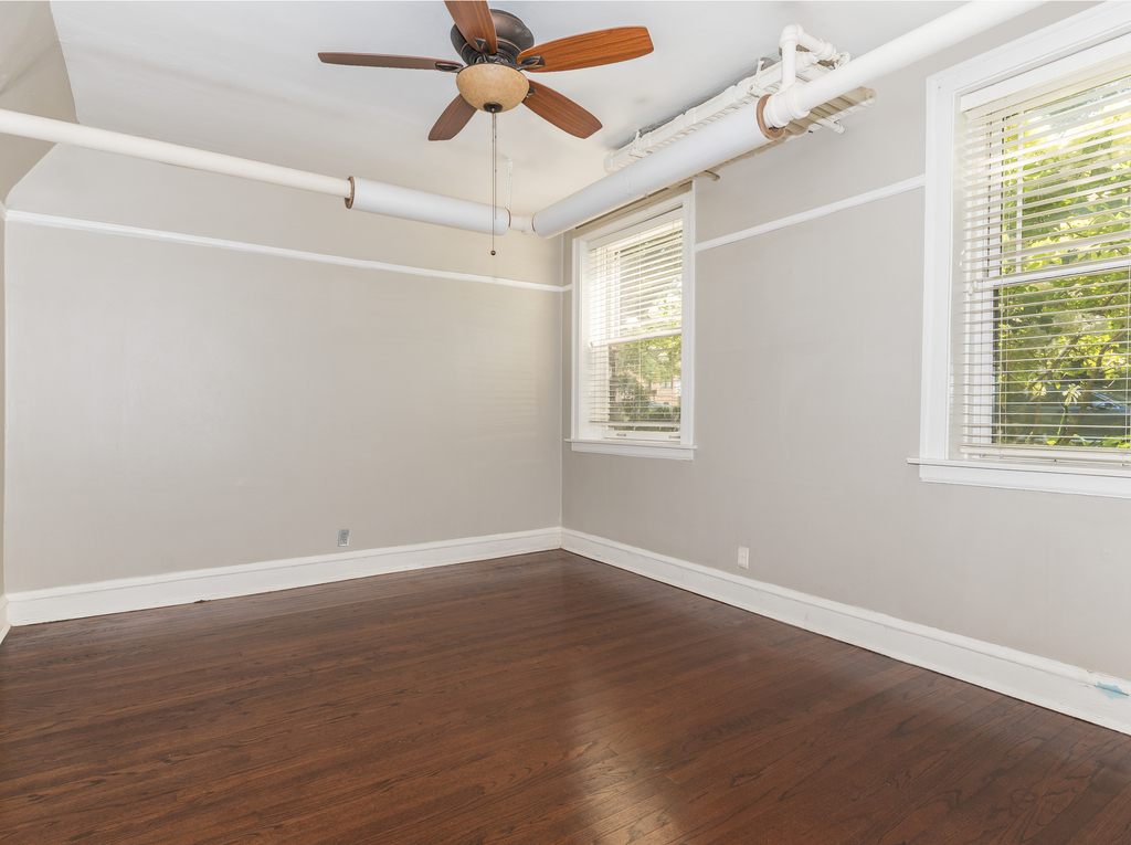520 Sheridan Road, Unit G Evanston, IL 60202 - Photo 8 of 16 an empty room with wooden floor fan and windows