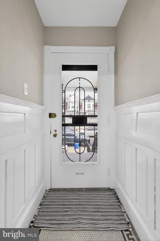 a view of a hallway with wooden floor and a cabinet