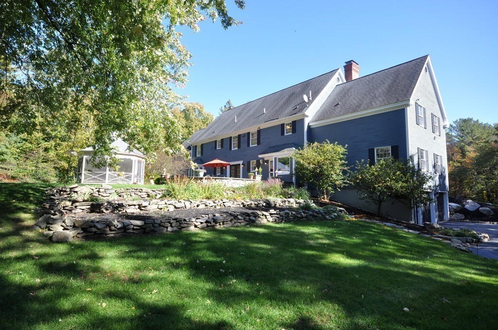 5 Partridge Pond Road Acton, MA 01720 - Photo 20 of 26 a front view of a house with a garden