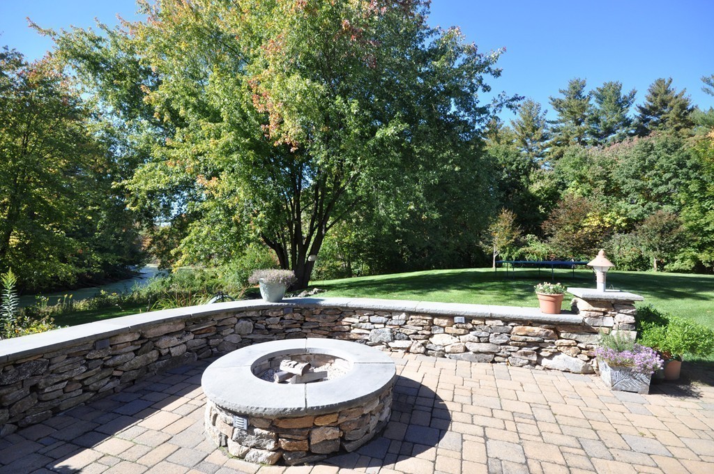5 Partridge Pond Road Acton, MA 01720 - Photo 23 of 26 a view of a backyard with table and chairs potted plants and tree