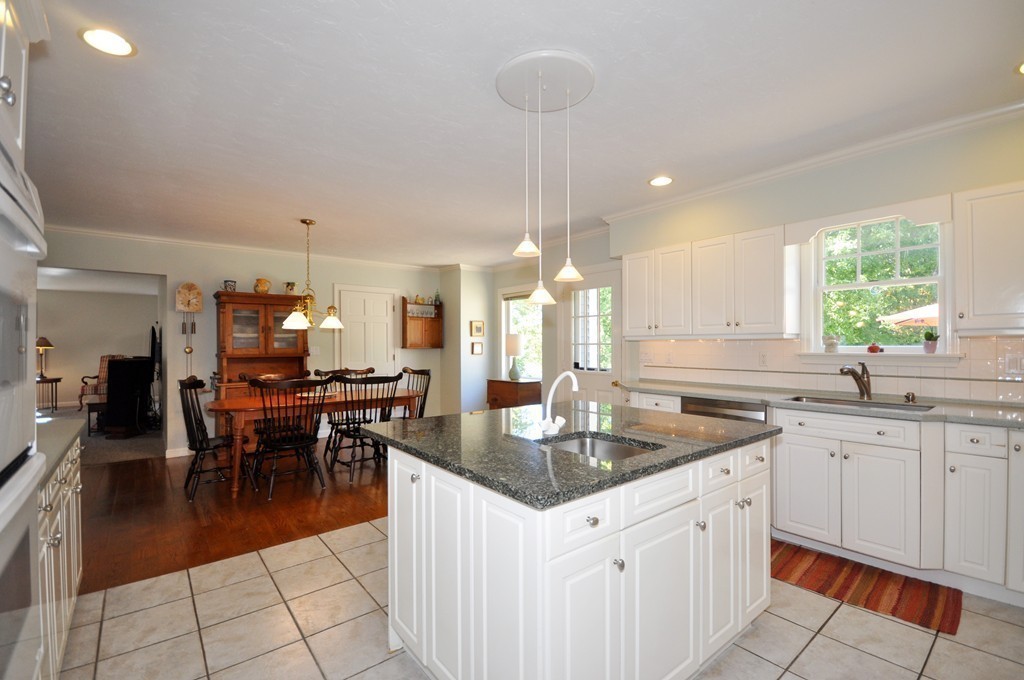 5 Partridge Pond Road Acton, MA 01720 - Photo 6 of 26 a kitchen with granite countertop a sink a counter top space appliances and cabinets