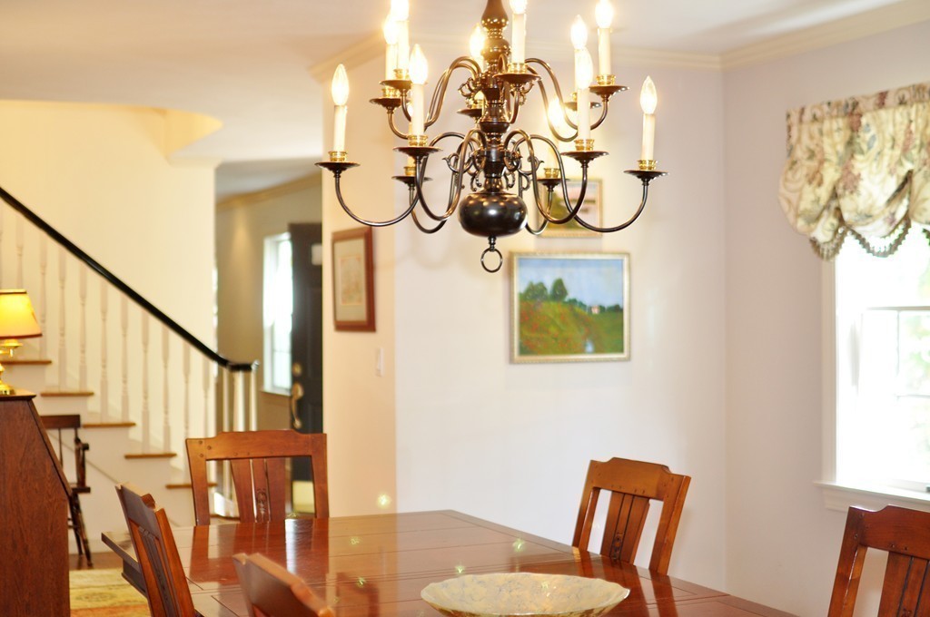 5 Partridge Pond Road Acton, MA 01720 - Photo 7 of 26 a view of a dining room with furniture wooden floor and a chandelier
