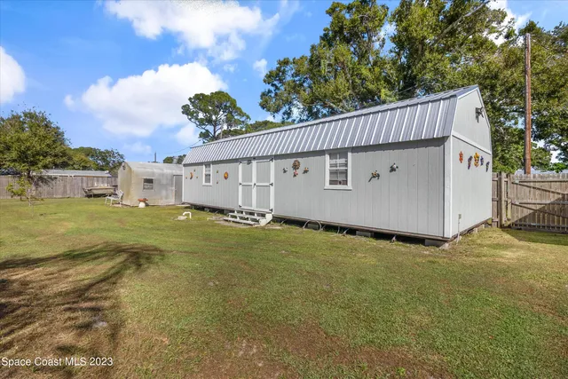a view of a house with backyard porch and sitting area