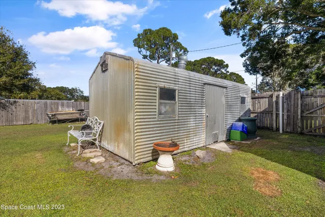 an aerial view of residential houses with yard