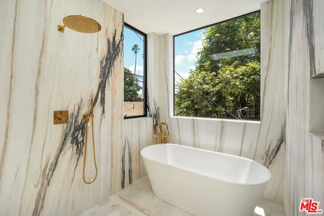 a bathroom with a double vanity sink and mirror