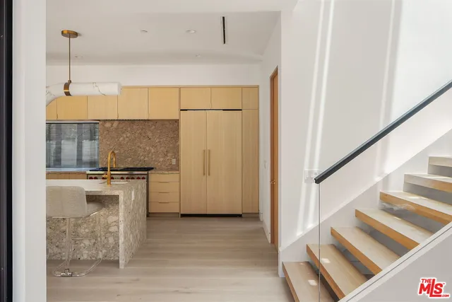a kitchen with a refrigerator a stove and a sink