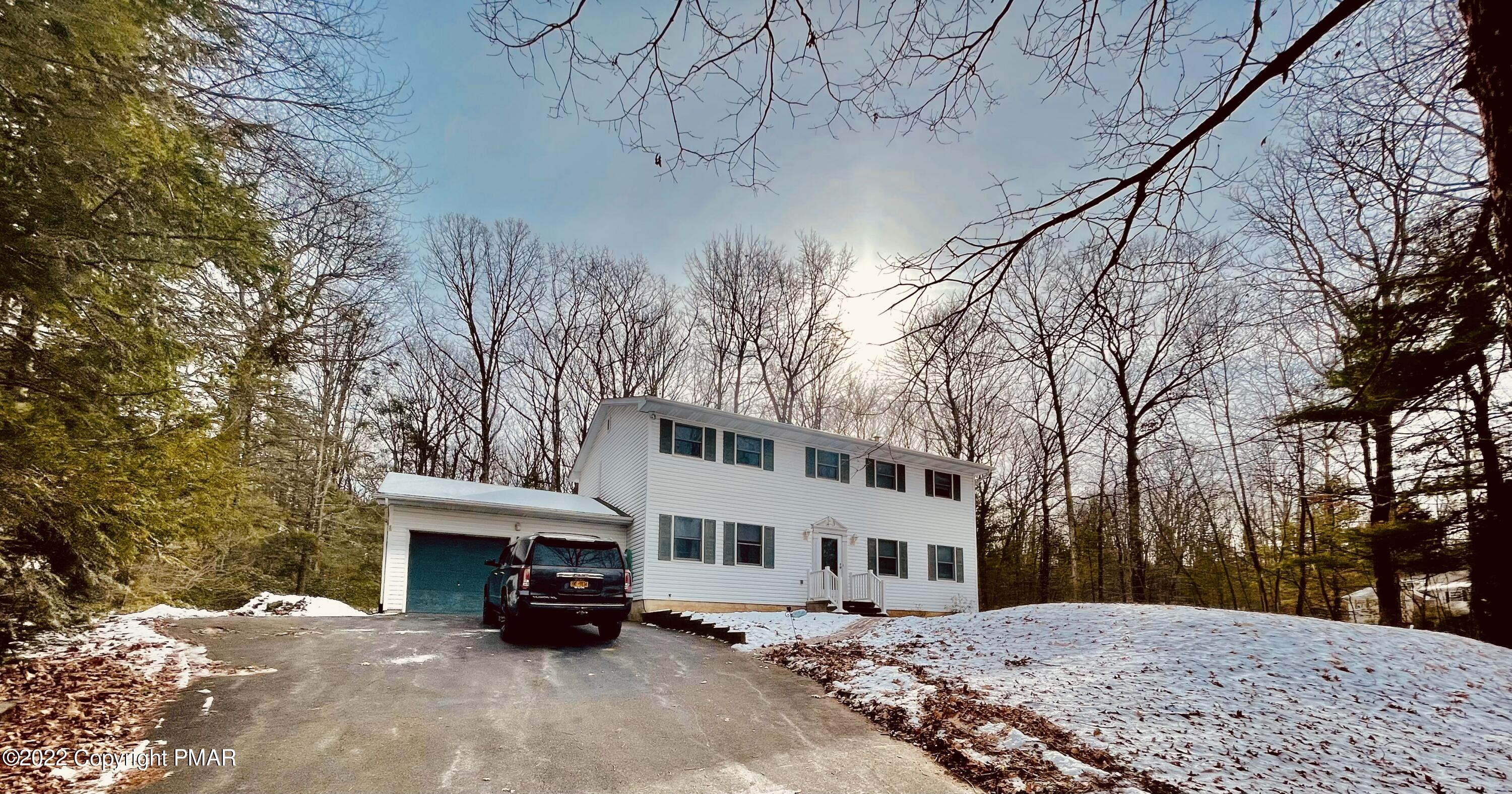 a view of a house with a snow in front of house