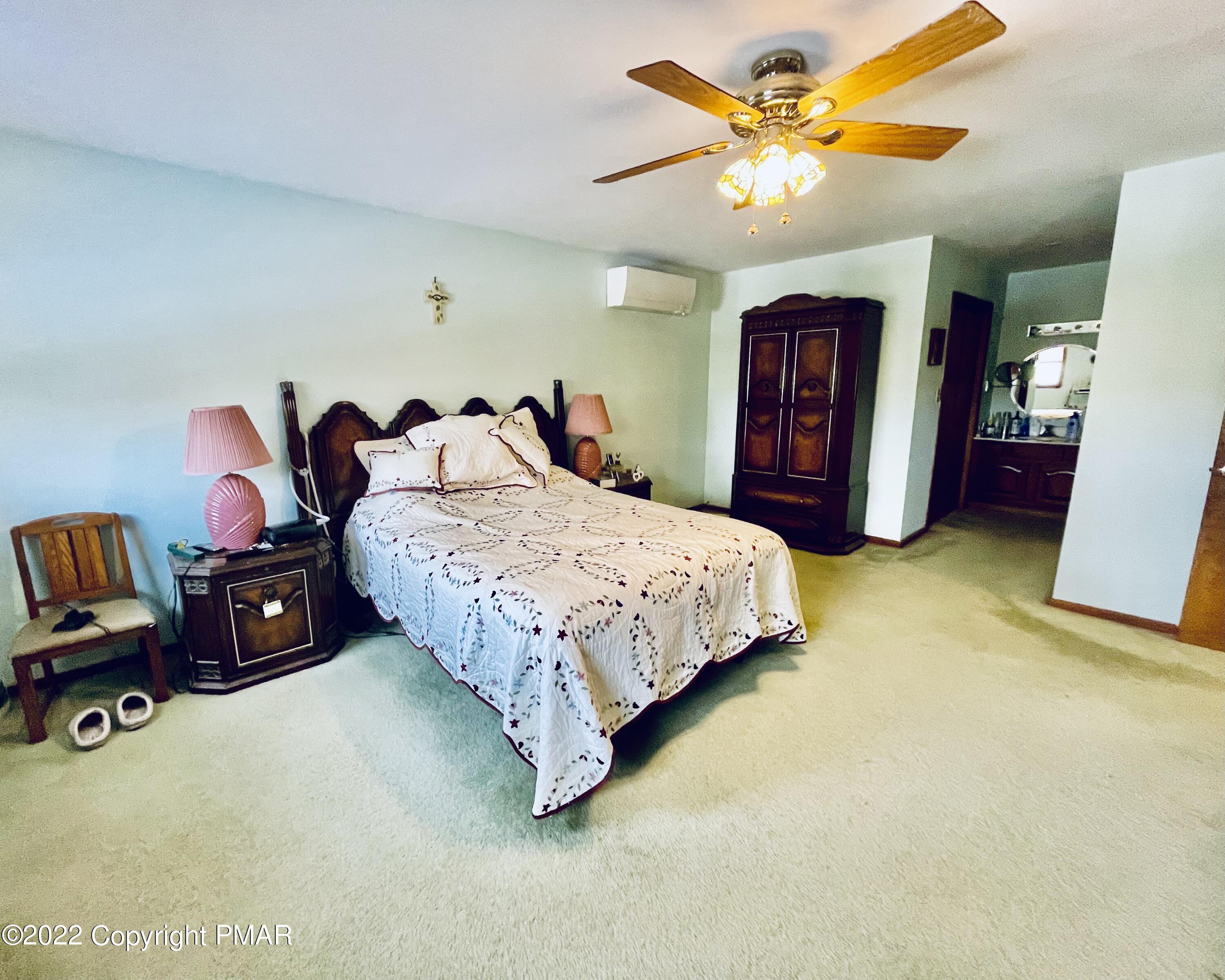 165 Comanche Pines Road Effort, PA 18330 - Photo 11 of 20 a bedroom with a bed and a furniture