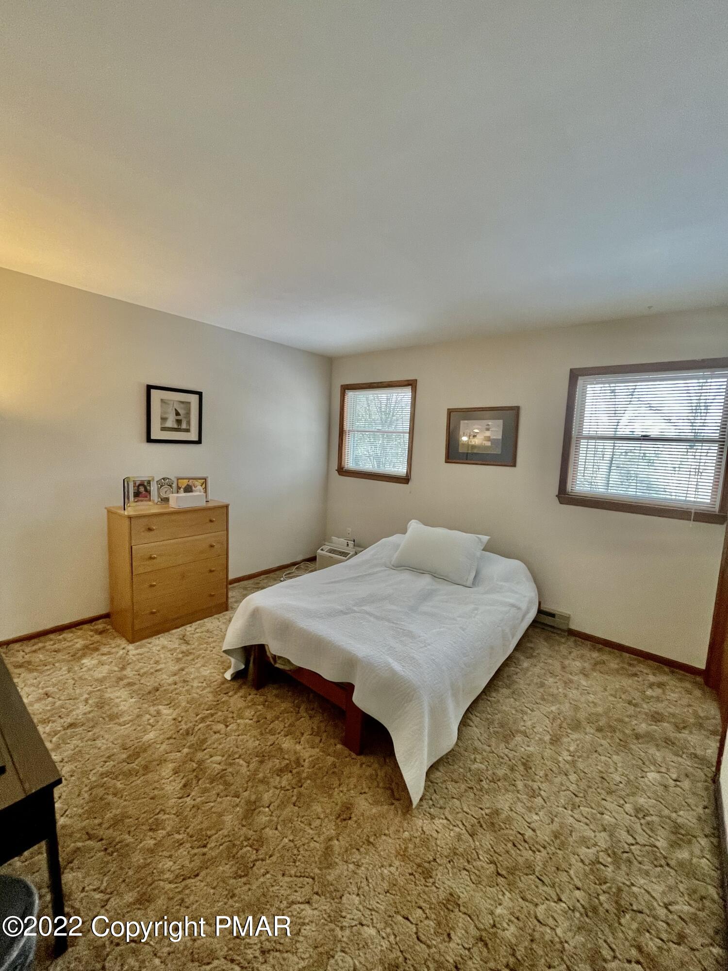 165 Comanche Pines Road Effort, PA 18330 - Photo 15 of 20 a bedroom with a bed and painting on the wall