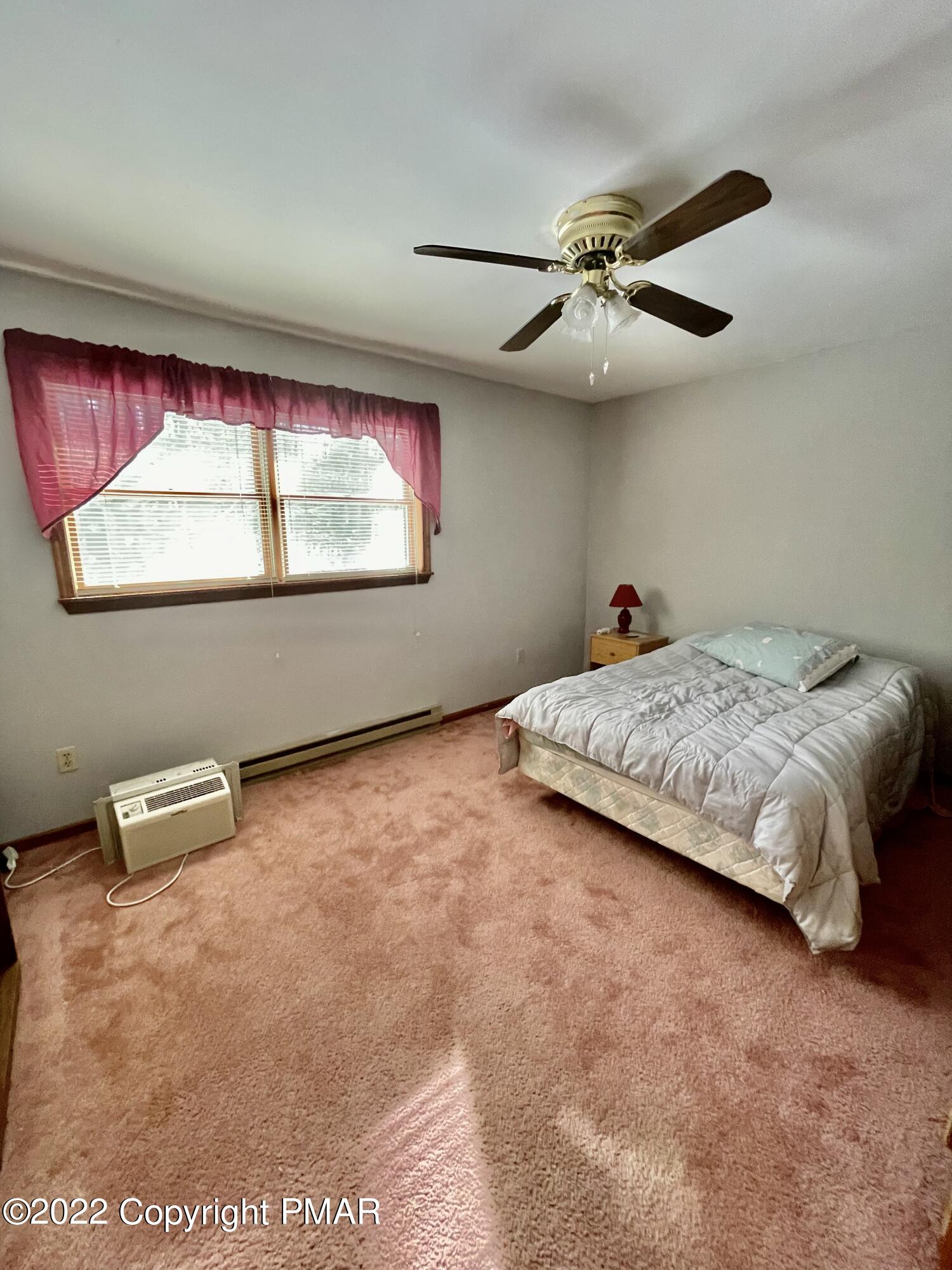 165 Comanche Pines Road Effort, PA 18330 - Photo 17 of 20 a bedroom with a bed and a window