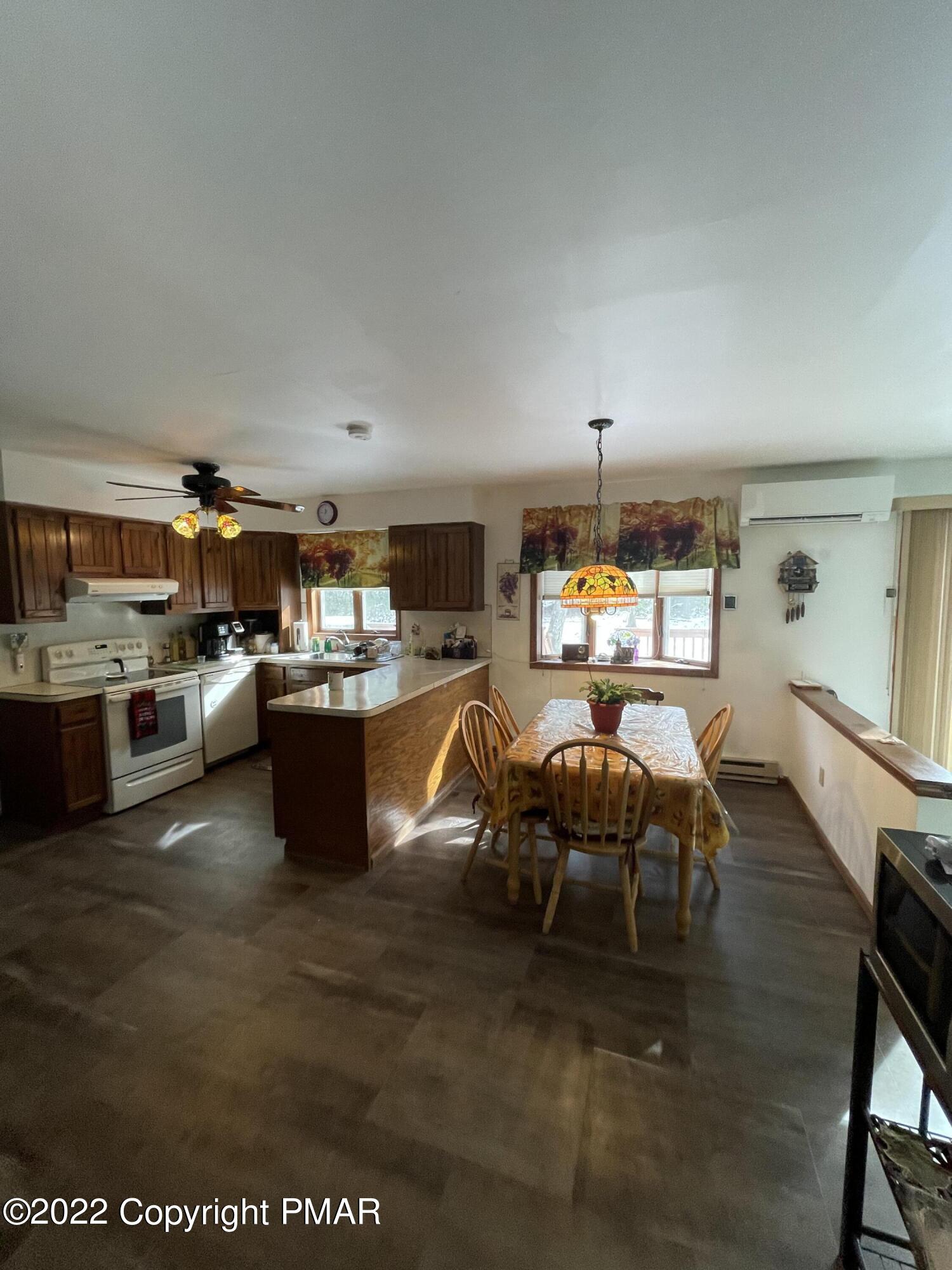 165 Comanche Pines Road Effort, PA 18330 - Photo 4 of 20 a living room with lots of furniture and kitchen view