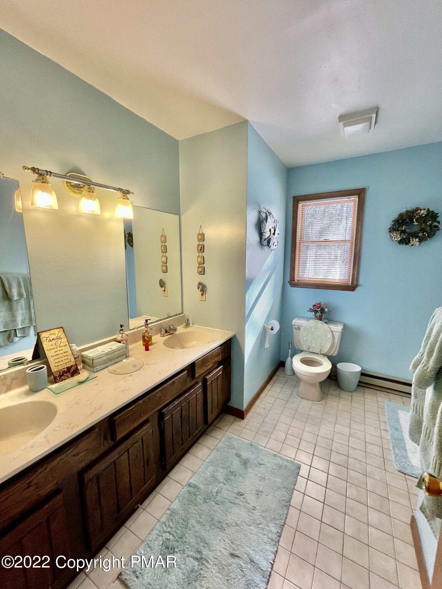 165 Comanche Pines Road Effort, PA 18330 - Photo 10 of 20 a spacious bathroom with a double vanity sink a toilet and a mirror