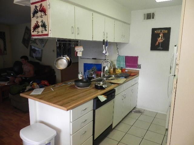 910 Duncan Lane, Unit 49 Austin, TX 78705 - Photo 14 of 27 a kitchen with a sink a stove and a refrigerator