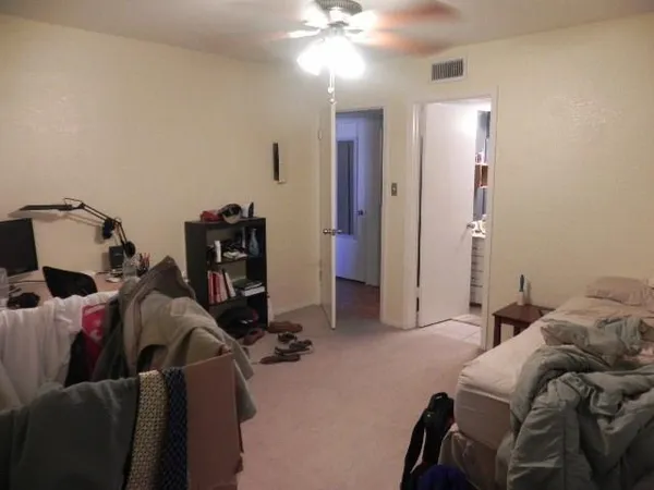 a bedroom with a bed and a couch