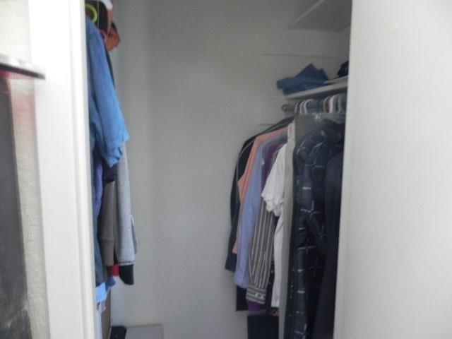 910 Duncan Lane, Unit 49 Austin, TX 78705 - Photo 21 of 27 a view of walk in closet with clothes and shoes