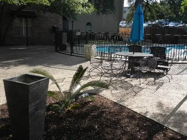 a view of a patio with a table and chairs