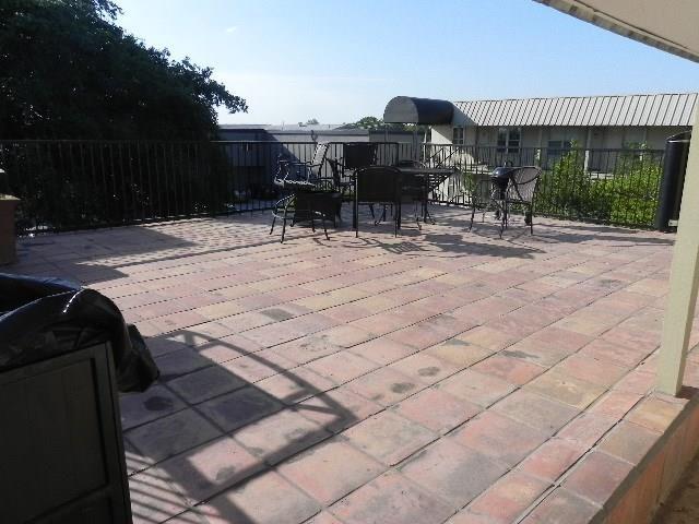 910 Duncan Lane, Unit 49 Austin, TX 78705 - Photo 9 of 27 a patio with table and chairs and potted plants