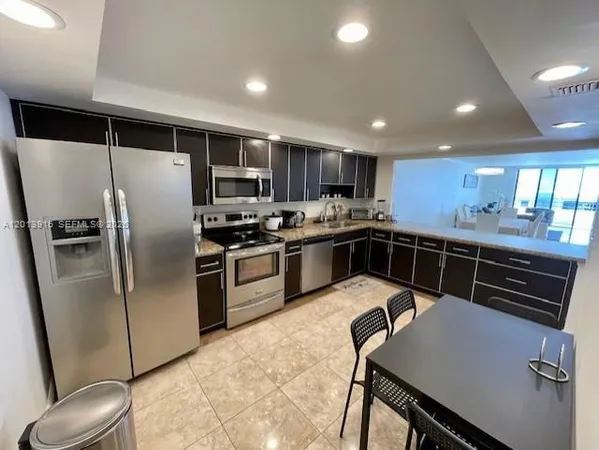 a kitchen with stainless steel appliances a stove a sink and a microwave