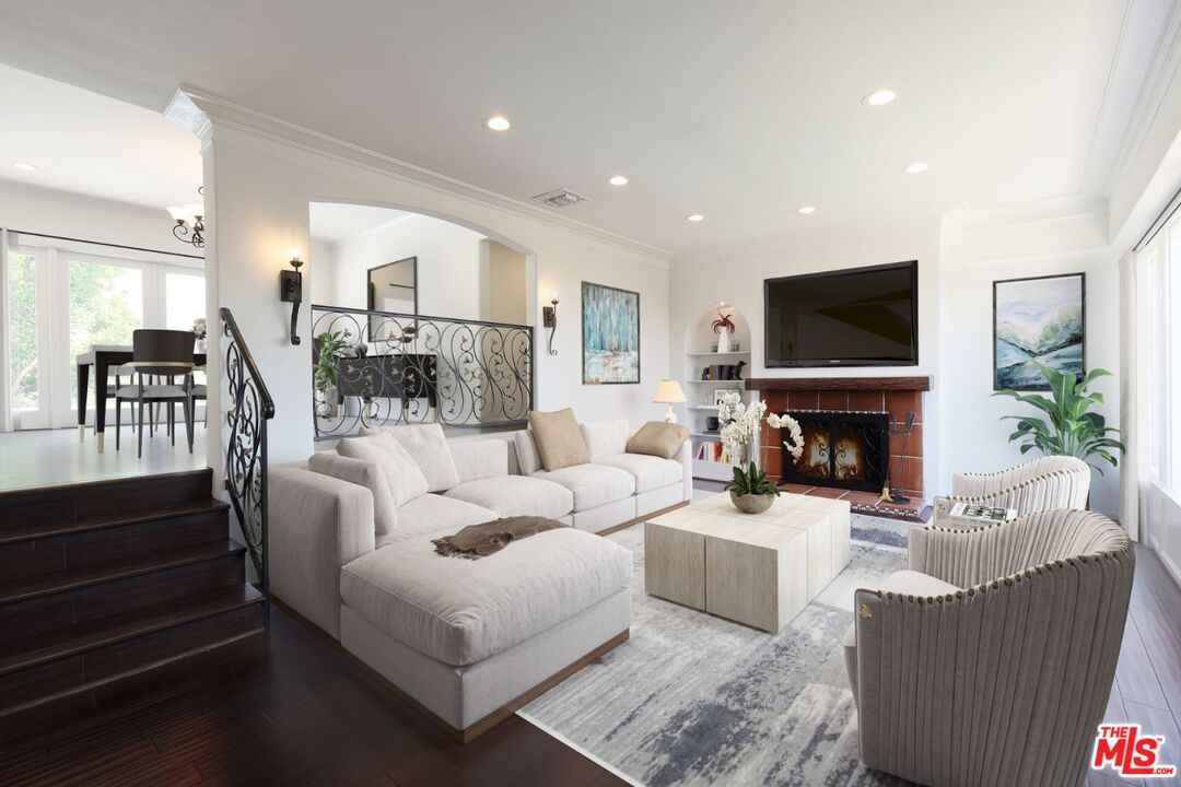 a living room with fireplace furniture and a flat screen tv