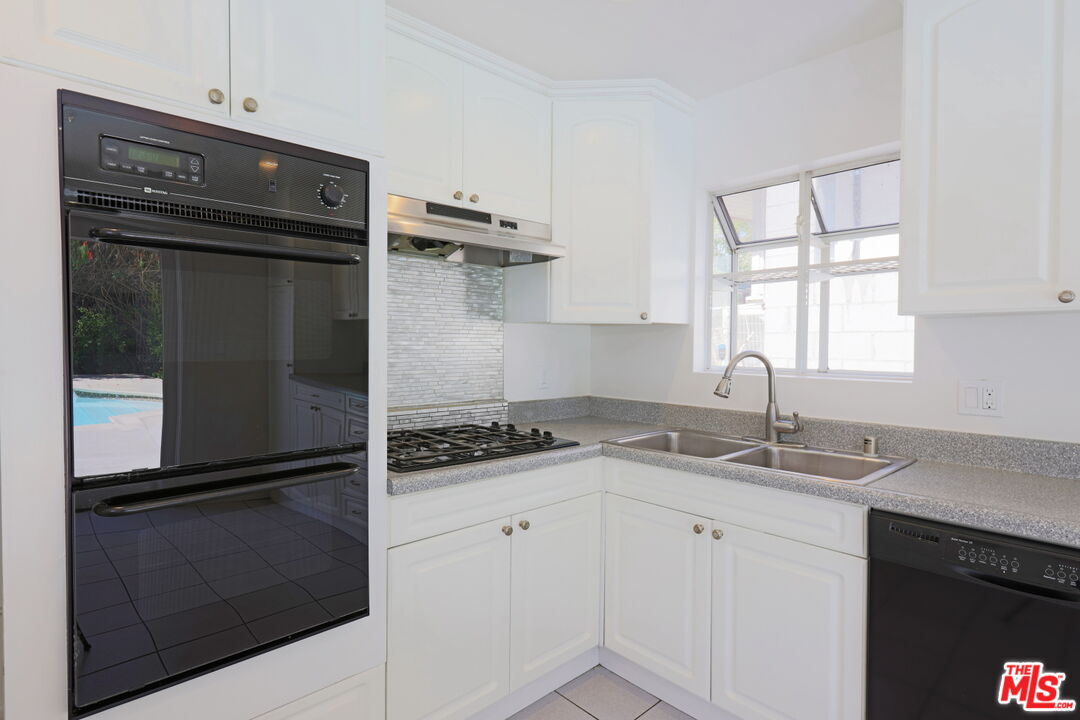600 Luton Drive Glendale, CA 91206 - Photo 11 of 50 a kitchen with a refrigerator and a sink