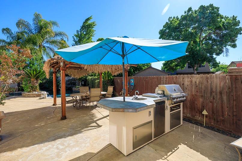 2001 Dayton Avenue Modesto, CA 95356 - Photo 12 of 94 a patio with a table and chairs under an umbrella