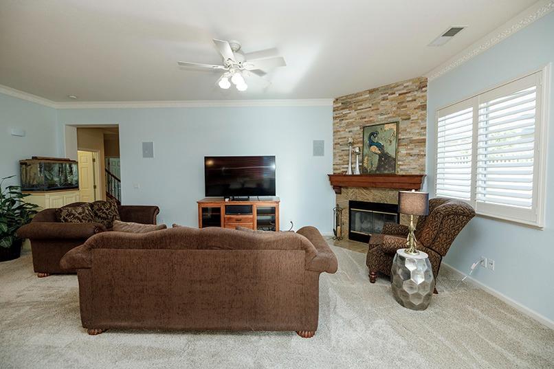 2001 Dayton Avenue Modesto, CA 95356 - Photo 30 of 94 a living room with furniture a fireplace and a flat screen tv