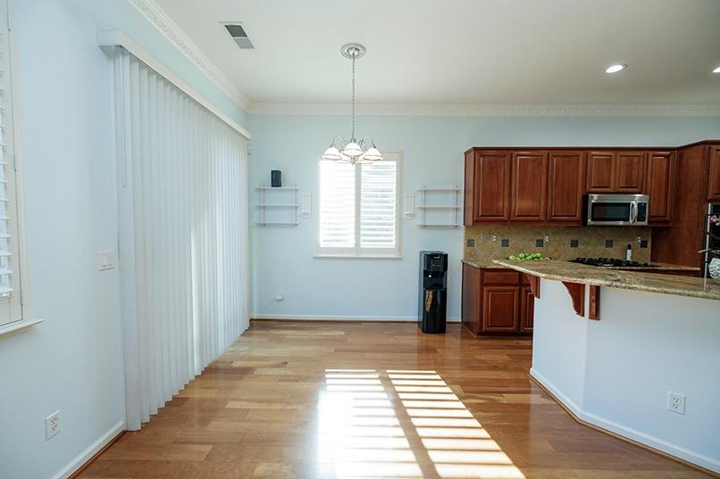 2001 Dayton Avenue Modesto, CA 95356 - Photo 33 of 94 a kitchen with granite countertop a stove a sink and a microwave