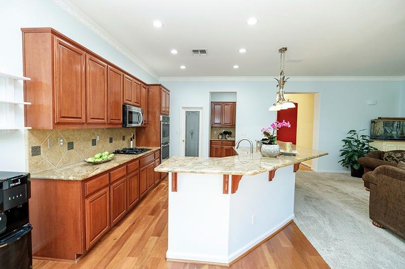 2001 Dayton Avenue Modesto, CA 95356 - Photo 44 of 94 a large kitchen with stainless steel appliances granite countertop a lot of counter space and wooden floor