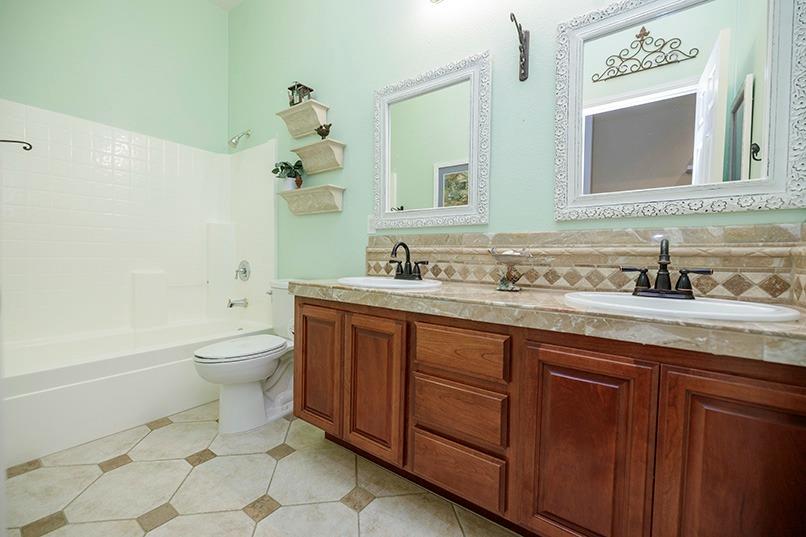 2001 Dayton Avenue Modesto, CA 95356 - Photo 64 of 94 a bathroom with a toilet sink and mirror