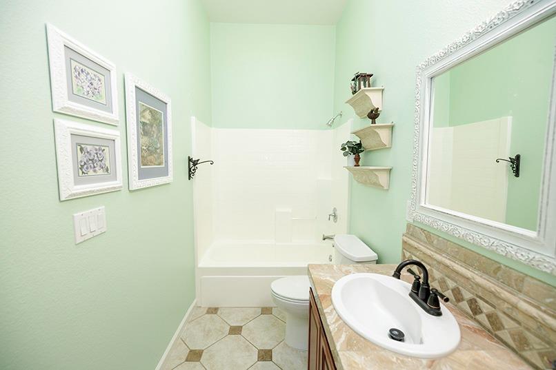 2001 Dayton Avenue Modesto, CA 95356 - Photo 65 of 94 a bathroom with a sink a toilet and shower