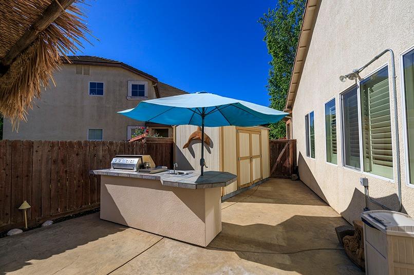 2001 Dayton Avenue Modesto, CA 95356 - Photo 75 of 94 a view of a tables and chairs under an umbrella in patio