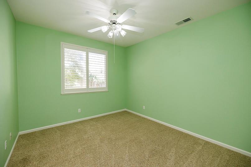 2001 Dayton Avenue Modesto, CA 95356 - Photo 89 of 94 an empty room with a window and a ceiling fan