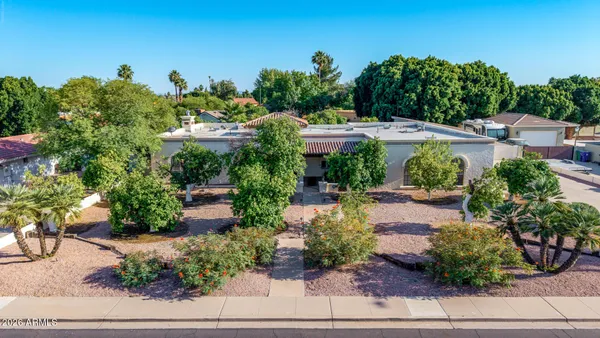 an aerial view of a house with a yard and lake view