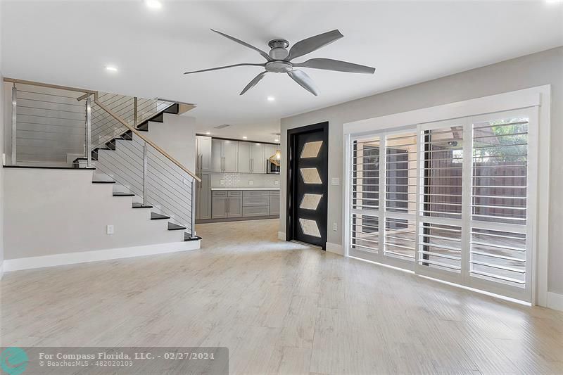 825 Center Street Jupiter, FL 33458 - Photo 12 of 37 a view of an empty room with wooden floor and a ceiling fan